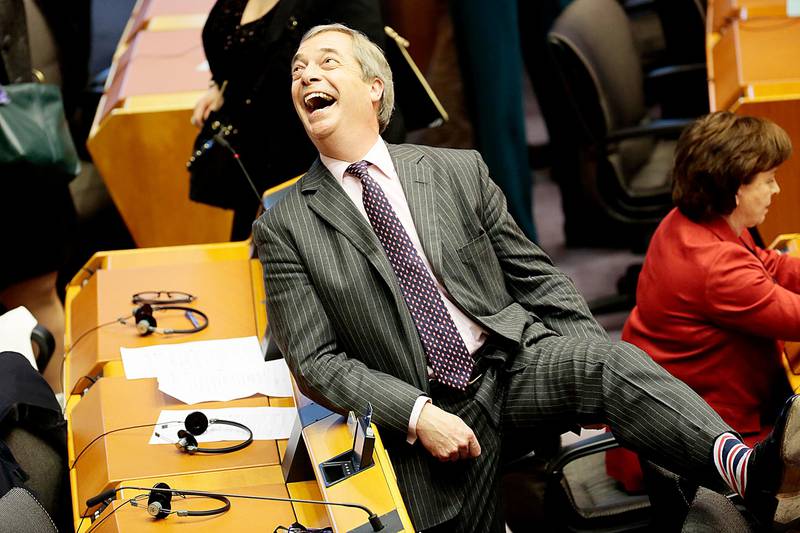 Brexit Party leader Nigel Farage, shows off his Union flag socks ahead of a vote on the UK's withdrawal from the EU during the plenary session at the European Parliament in Brussels, Wednesday, Jan. 29, 2020. The U.K. is due to leave the EU on Friday, Jan. 31, 2020, the first nation in the bloc to do so. (AP Photo/Virginia Mayo)
