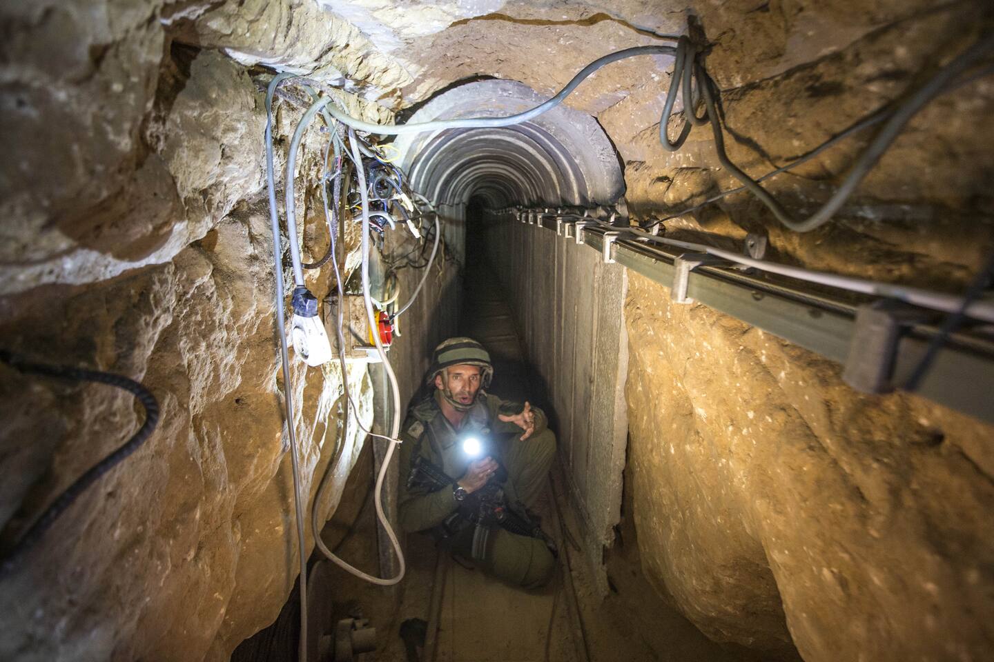 An Israeli army officer gives journalists a tour, Friday, July 25, 2014, of a tunnel allegedly used by Palestinian militants for cross-border attacks, at the Israel-Gaza Border. A network of tunnels Palestinian militants have dug from Gaza to Israel, dubbed "lower Gaza" by the Israeli military, is taking center stage in the latest war between Hamas and Israel. (AP Photo/Jack Guez, Pool)
