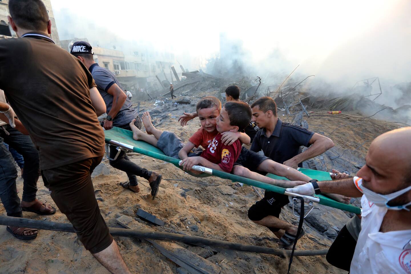 To palestinske gutter fraktes vekk fra en sammenrast bygning i Gaza by 25. oktober. Foto: Abed Khaled / AP / NTB