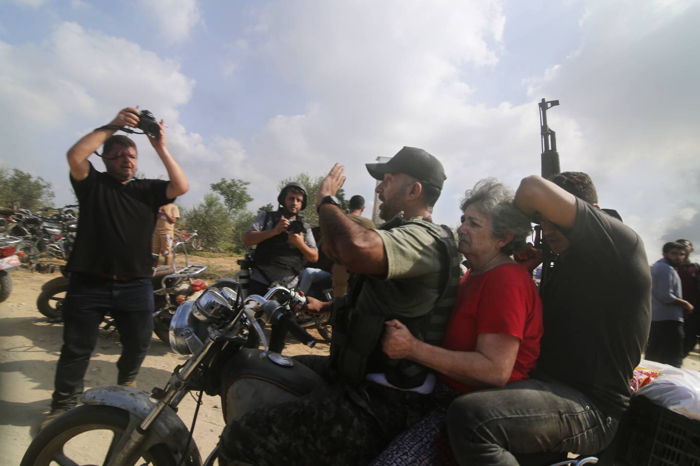 FILE - Palestinians transport a captured Israeli civilian, Adina Moshe, from her home in Kibbutz Nir Oz to the Gaza Strip, Oct. 7, 2023. The 72-year-old Israeli woman held captive by Hamas militants for nearly 50 days told an Israeli TV channel Wednesday, Jan. 24, 2024, that she was held at length in a dark, humid tunnel where she met Hamas’ leader and helped pass the time with a makeshift lecture series by her knowledgeable fellow hostages. (AP Photo, File)