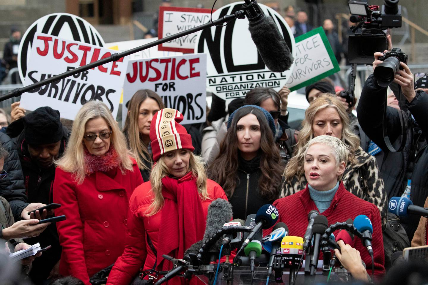 FILE - In this Jan. 6, 2020, file photo, Actor Rose McGowan, right, speaks at a news conference as actor Rosanna Arquette, center left, listens outside a Manhattan courthouse after the arrival of Harvey Weinstein in New York. (AP Photo/Mark Lennihan, File)