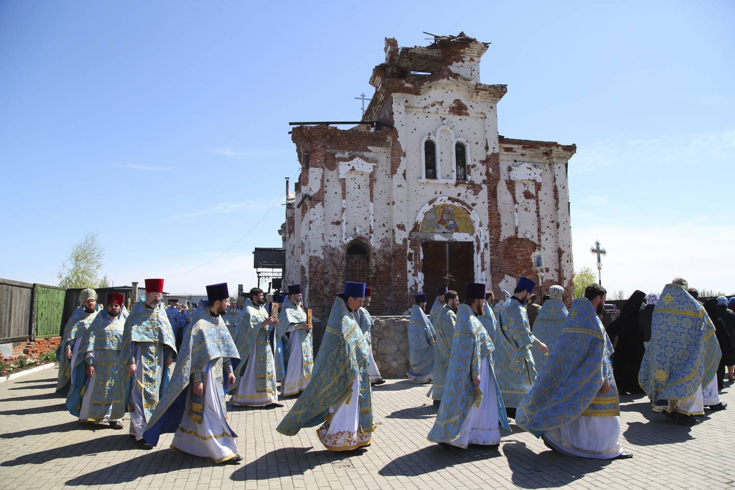 Priests attend a religion procession celebrating Orthodox Easter at the Iversky Monastery a monastery of the Ukrainian Orthodox Church (Moscow Patriarchate) damaged by shelling, outside Donetsk, Ukraine, Tuesday, May 4, 2021. (AP Photo/Alexei Alexandrov)