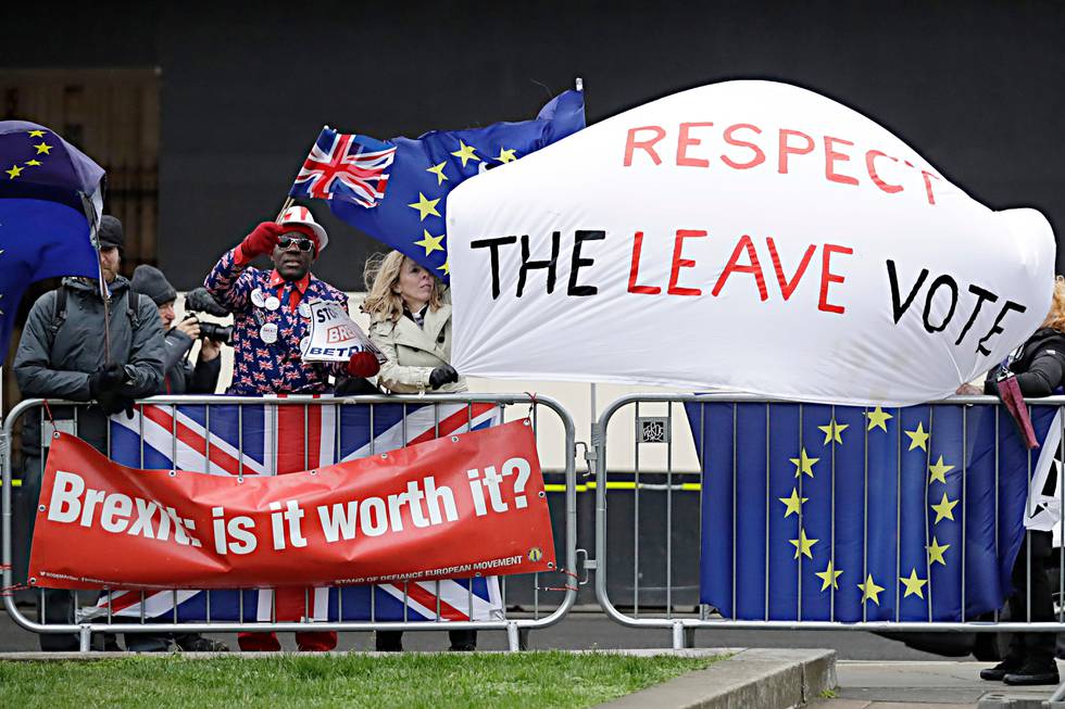 Pro-Brexit leave the European Union supporters and anti-Brexit remain in the European Union supporters take part in a protest outside the Houses of Parliament in London, Tuesday, March 12, 2019. British Prime Minister Theresa May faced continued opposition to her European Union divorce deal Tuesday despite announcing what she described as "legally binding" changes in hopes of winning parliamentary support for the agreement. (AP Photo/Matt Dunham)