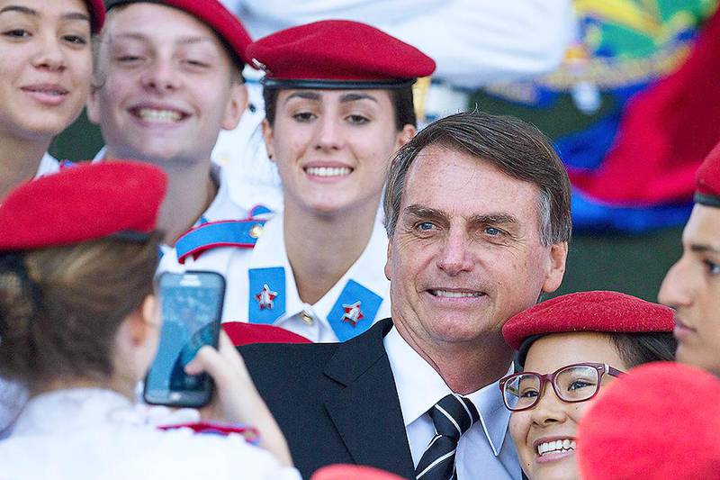 Brazilian congressman Jair Bolsonaro poses for photos with soldiers and cadets during a a ceremony commemorating Army Day, in Brasilia, Brazil, Wednesday, April 19, 2017. Bolsonaro, a potential presidential candidate for Brazil's 2018 election, is backed by the military and some conservative sectors. (AP Photo/Eraldo Peres)