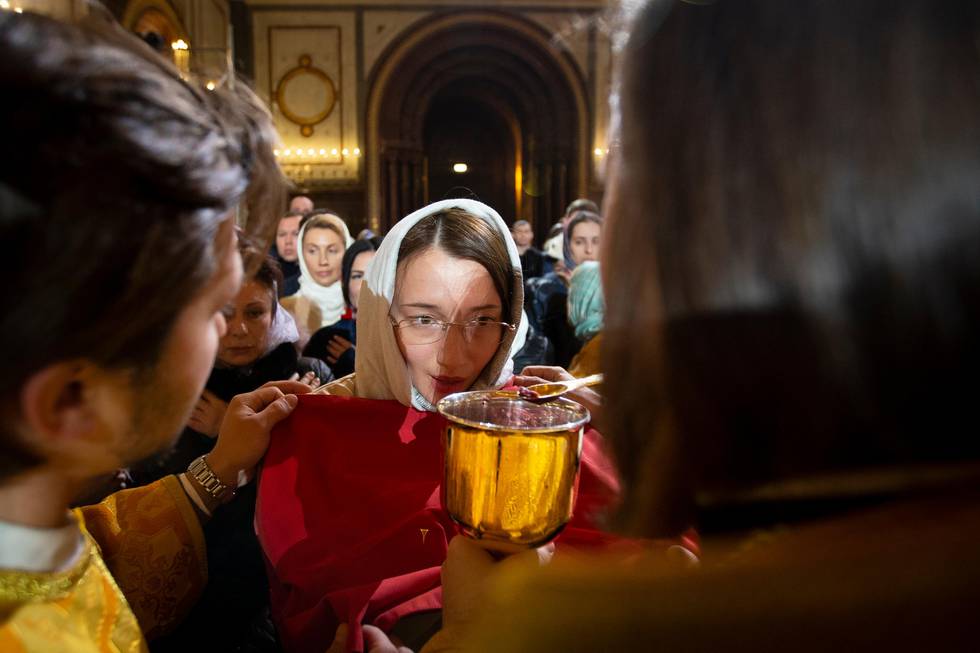 Orthodox believers attend a communion after the Christmas Mass in the Christ the Saviour Cathedral in Moscow, Russia, Tuesday, Jan. 7, 2020. Orthodox Christians celebrate Christmas on Jan. 7, in accordance with the Julian calendar. (AP Photo/Alexander Zemlianichenko)
