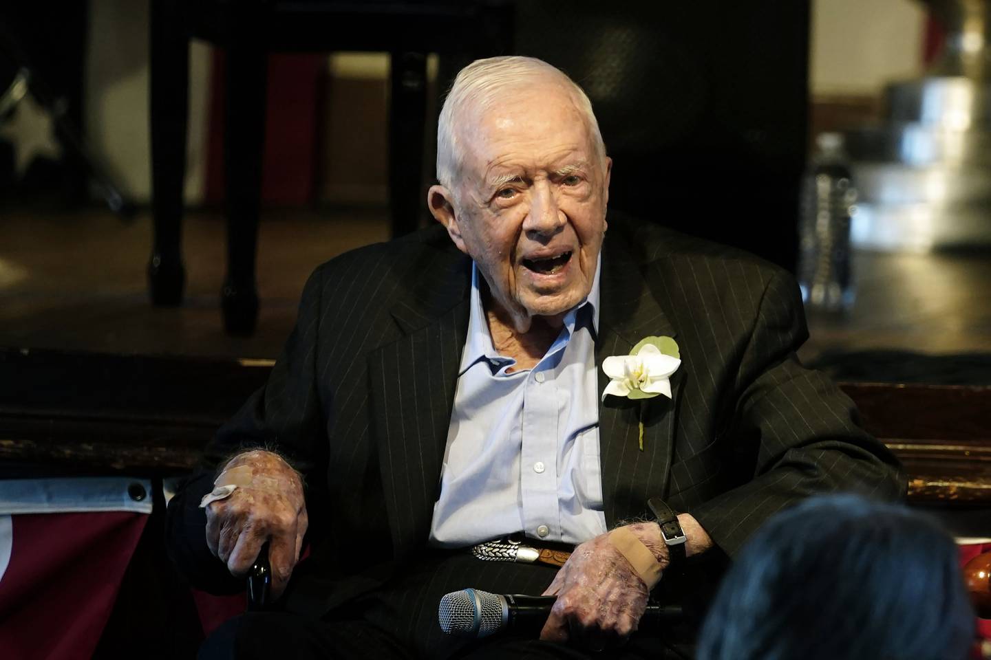 Former President Jimmy Carter reacts as his wife Rosalynn Carter speaks during a reception to celebrate their 75th wedding anniversary Saturday, July 10, 2021, in Plains, Ga.. (AP Photo/John Bazemore, Pool)
