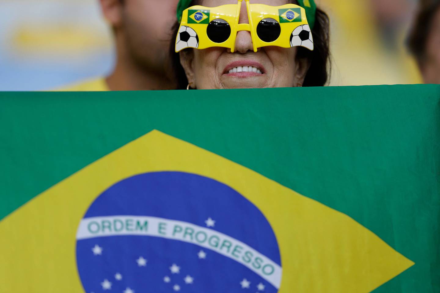 A fan holds a Brazilian flag before the final match of the women's Olympic football tournament between Germany and Sweden at the Maracana stadium in Rio de Janeiro, Brazil, Friday Aug. 19, 2016. (AP Photo/Leo Correa)