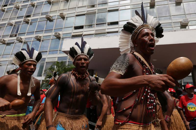 Indigenous people of the Pataxo ethnicity, from the state of Bahia, take part in a protest on the esplanade of the Ministries in Brasilia, Brazil, Tuesday, Feb. 20, 2018. The group is camped with representatives of other tribes and social movements, and are protesting against the government policies of Brazil's President Michel Temer, land demarcation and health policies in indigenous communities. (AP Photo/Eraldo Peres)