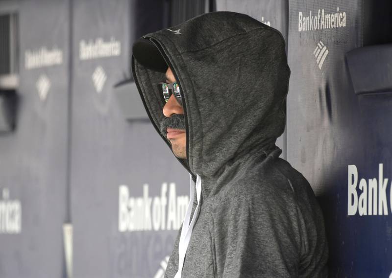 Ichiro Suzuki, special assistant to the chairman of the Seattle Mariners, wears a fake mustache and a hoodie as he sits in the dugout and watches the New York Yankees bat during the first inning of a baseball game Thursday, June 21, 2018, at Yankee Stadium in New York. Suzuki donned a Bobby Valentine-style disguise and sneaked into the Seattle dugout to watch a bit of the action at Yankee Stadium. (AP Photo/Bill Kostroun)
