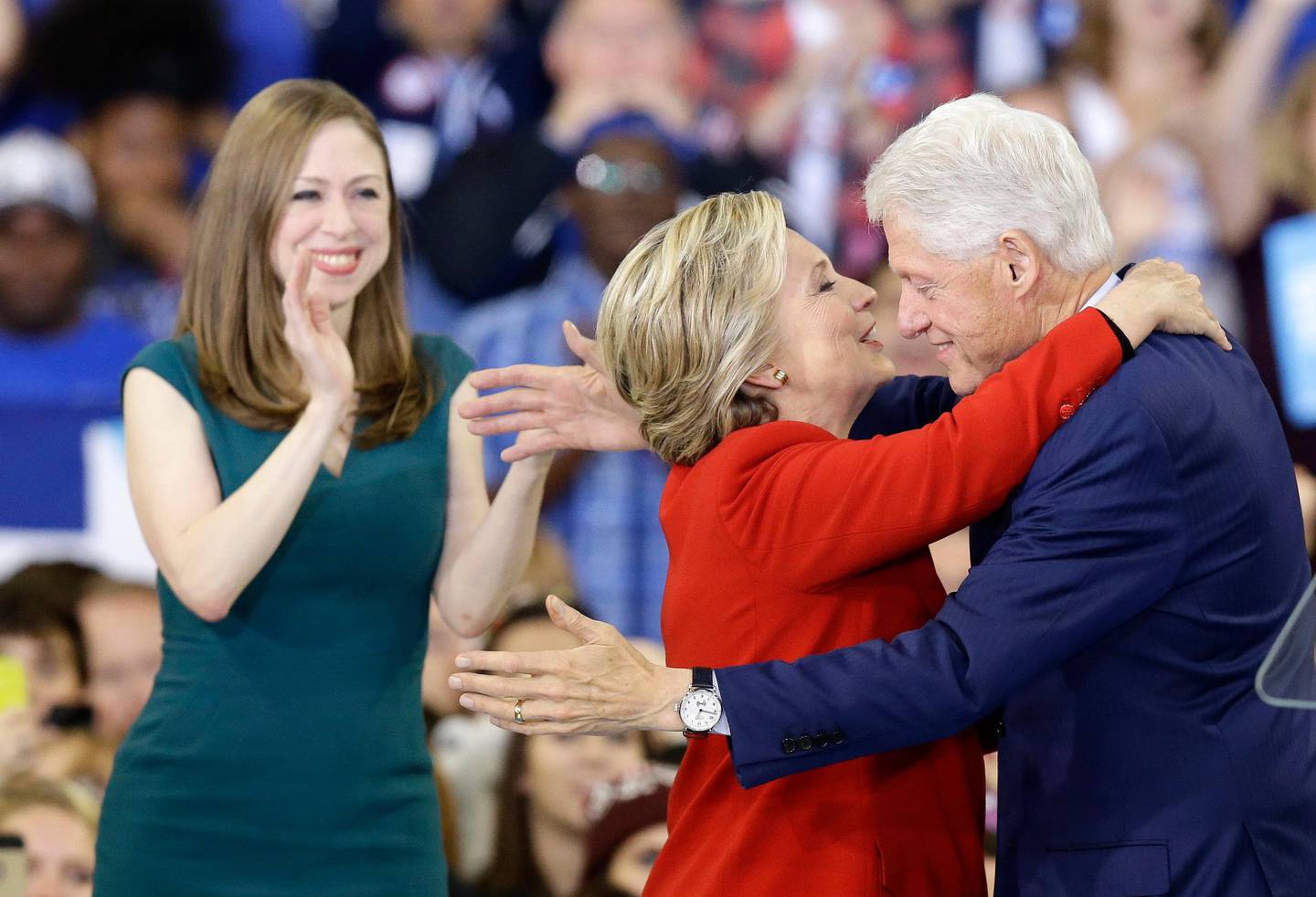 Democratic presidential candidate Hillary Clinton hugs her husband, former President Bill Clinton as their daughter Chelsea Clinton looks on during a campaign rally in Raleigh, N.C., Tuesday, Nov. 8, 2016. (AP Photo/Gerry Broome)