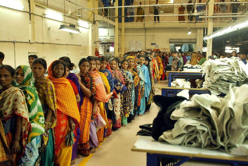 Bangladeshi women workers stand in line for security check, to go out for lunch at a textile factory on the outskirts of Dhaka, Bangladesh, Wednesday, Feb. 2, 2005. The European Union has decided to give Bangladesh zero tariff entry into its $ 70 billion clothing market from July this year, a move that may boost the country's export to the EU, according to media reports. Bangladesh, a nation of 140 million people, earns three-fourths of its foreign exchange from textile exports. The industry directly employs 1.8 million people and indirectly provides work for about 5 million.  (AP Photo/Manish Swarup)