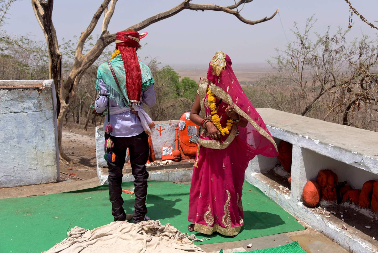 In this April 17, 2017 photograph, a child bride, who is only fourteen years old, right, performs rituals with the groom after getting married at a Hindu temple near Rajgarh, Madhya Pradesh state, India.  A significant fall in child marriages in South Asia has reduced the rate of marriage for girls globally, the U.N. children's agency said Tuesday. (AP Photo/Prakash Hatvalne)